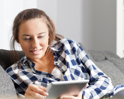 A college-age girl checking her account balances on her tablet